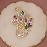 Jewelry brooch with multicolored gemstones on a decorative plate