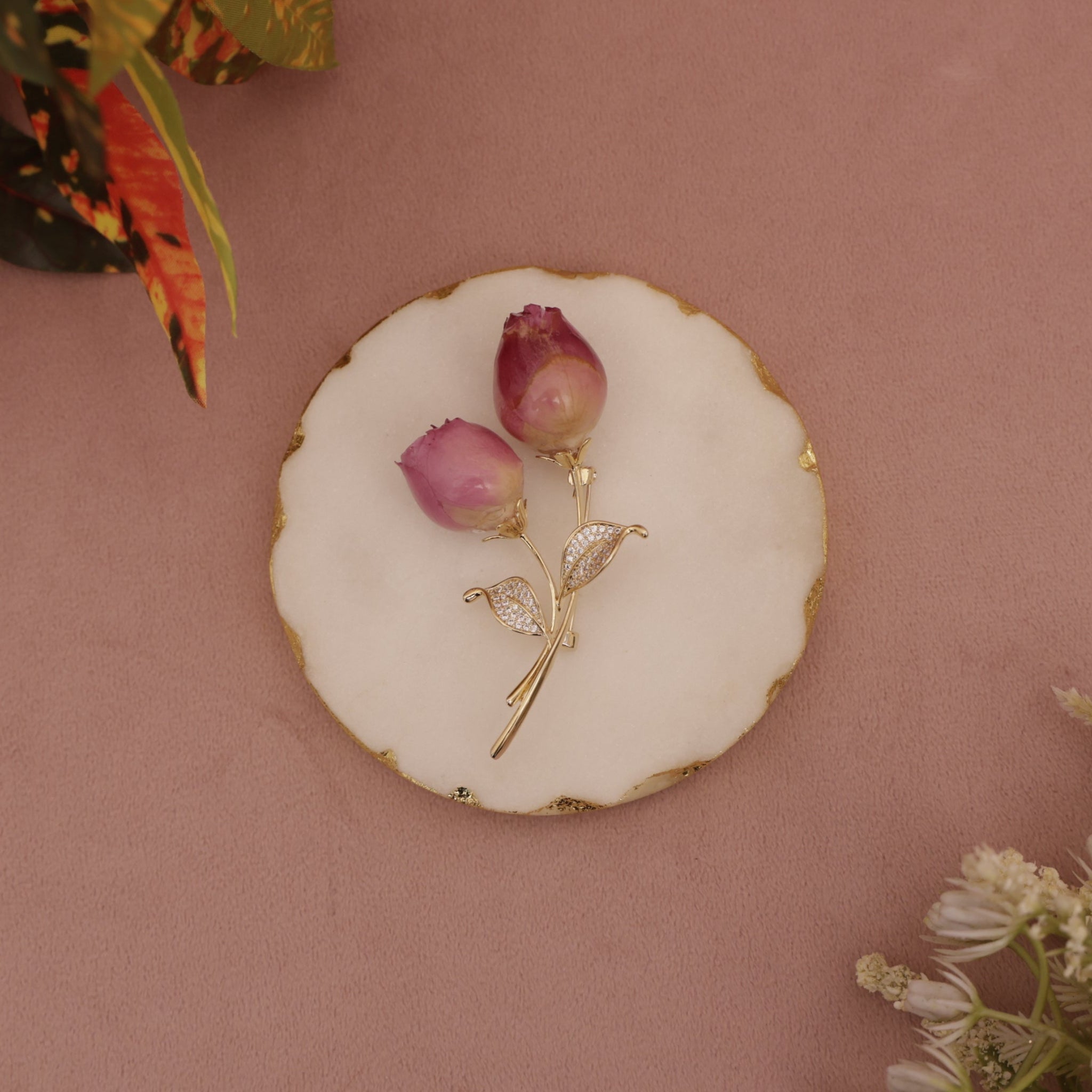 Gold brooch with pink flowers