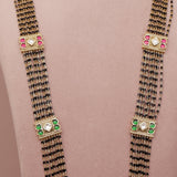 Long black beaded necklace with green and red accents
